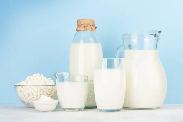 Różne Produkty Mleczne Mleko Ser Domek Śmietana Przed Niebieskim Tłem — Zdjęcie stockowe