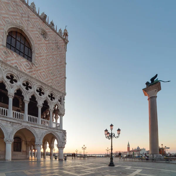 Outdoor cafe near Palace of doges on San Marco square at sunrise in Venice, Italy