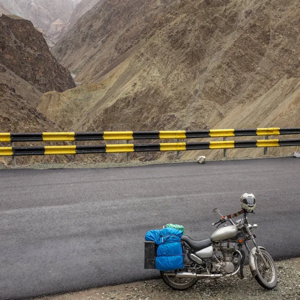 motorbike parked on high altitude road that traverses great Himalayan range, Ladakh, India