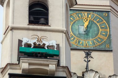 Tower of the City Hall on the Market square in Poznan, Poland. The mechanized goats, which are the symbol of the town, appearing once a day at noon clipart