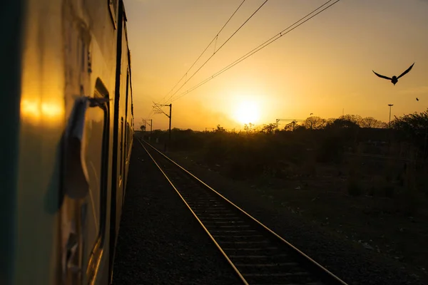 Train trip in India. Sunset view from the train to Delhi