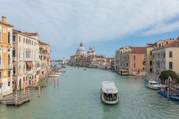 Venice, Italy - March 20, 2018: View of famous Grand canal with Basilica di Santa Maria della Salute in Venice, Italy