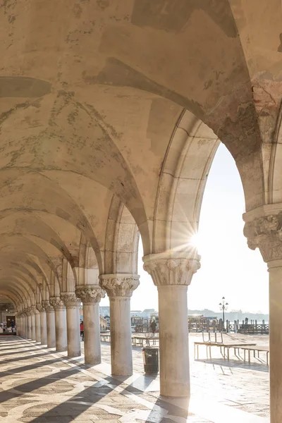 View through the archway underneath the Doge\'s Palace in San Marco Square, Venice, Italy