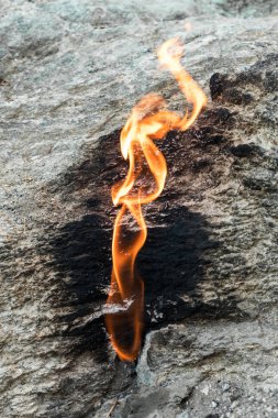Flames of Chimera Mount from the underground. Fire from the natural gas in the rocks in Cirali, Turkey. clipart