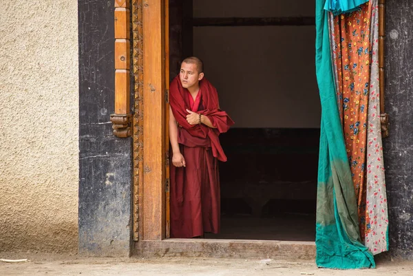 Тибетский буддийский монах смотрит фестиваль маски у дверей монастыря Ламаюру в Ладакхе, Индия — стоковое фото