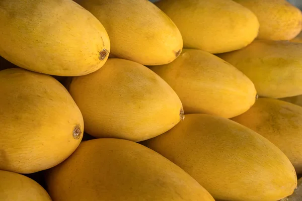 Pilha de amarelo fresco rasgou nomes de manga tailandesa Mamuang Kaew exibido na loja de frutas stall — Fotografia de Stock