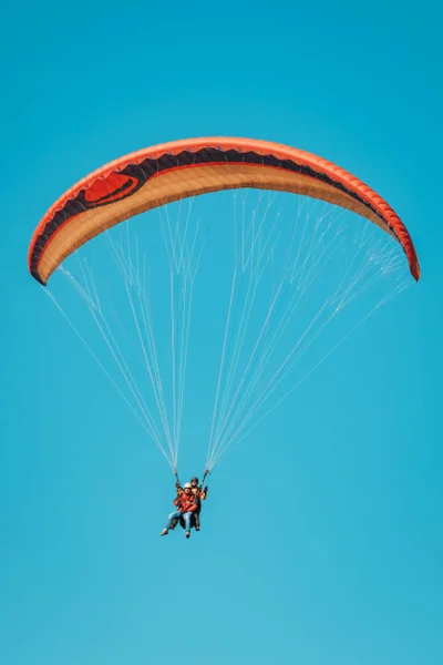 Colorful paraglider on blue bright sky — Stock Photo, Image