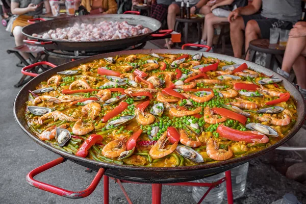 Big wok pan of spanish seafood paella with mussels, shrimps and vegetables