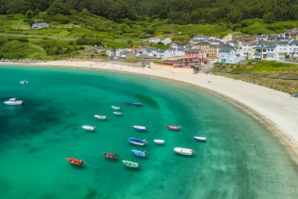 Aerial view of beautiful sandy beach and turquoise sea in O Porto de Bares, A Coruna, Galicia, Spain. Picturesque fishing village on the Atlantic Ocean coast with stunning natural scenery.