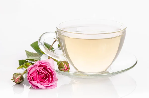 Glass cup of Tea with rose isolated on light table
