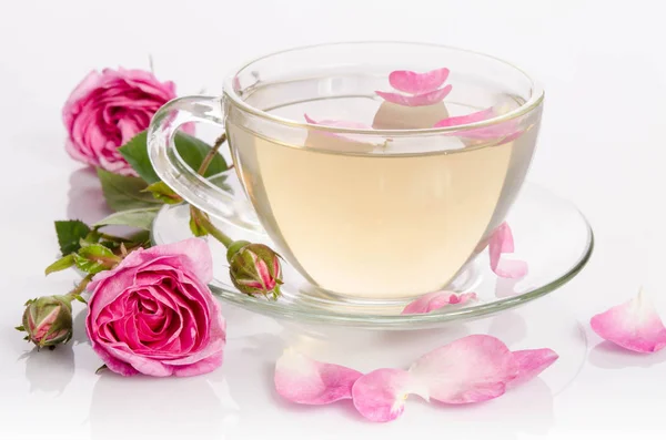 Glass cup of Tea with roses and petals