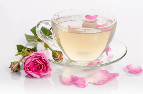 Glass cup of Tea with roses and petals