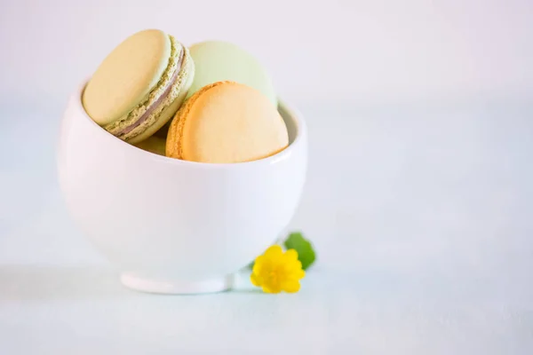 Macarons White Porcelain Bowl Blue Wooden Table Nice Yellow Flower — Stock Photo, Image