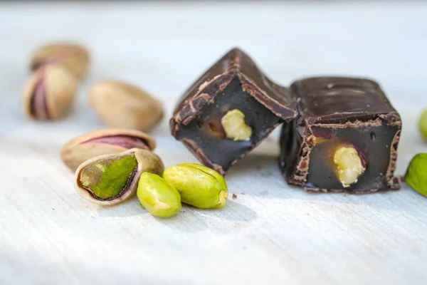 Eastern Turkish sweets with pistachios on a white wooden background