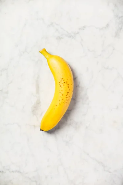 Banana on white marble table — Stock Photo, Image