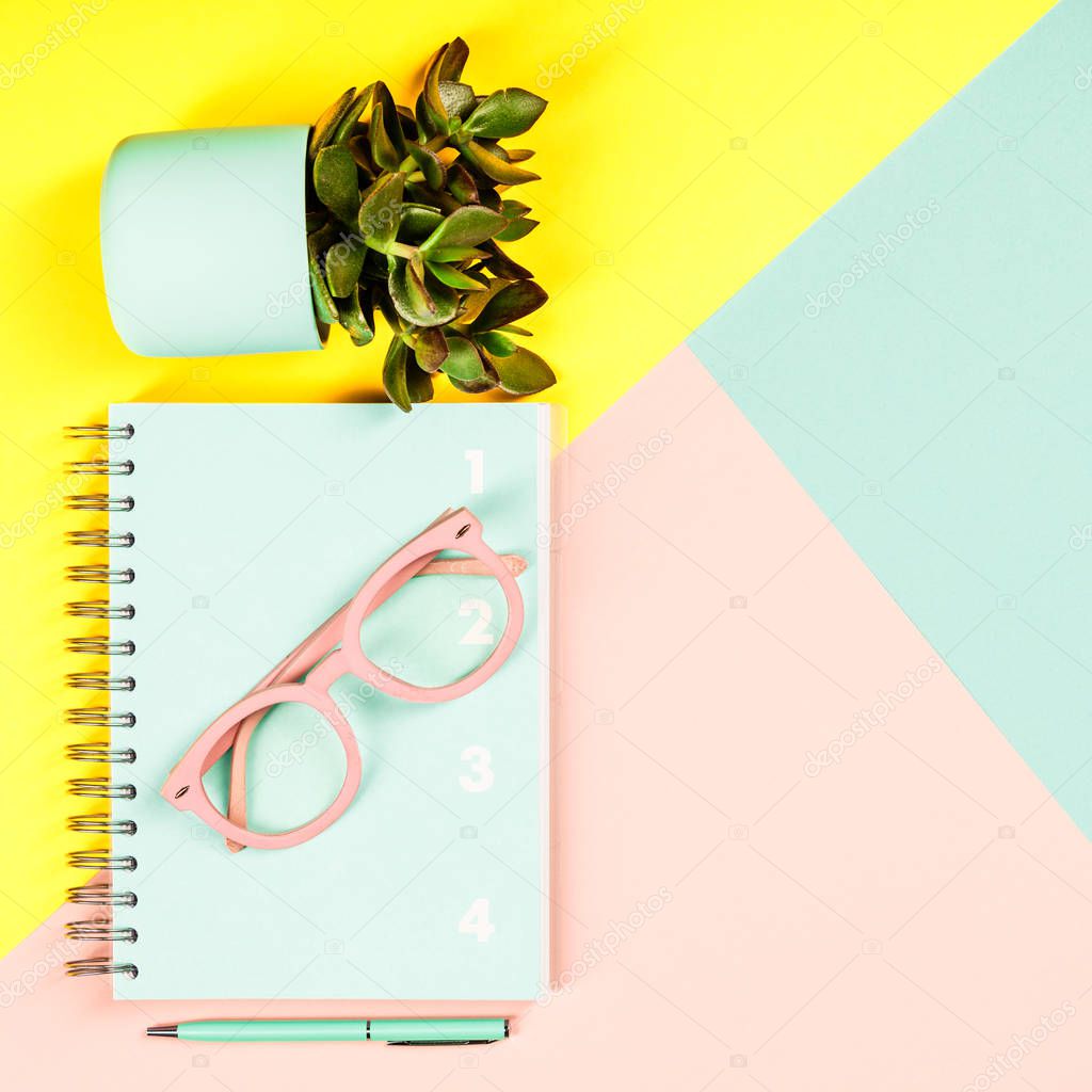 Creative flat lay on pastel colors background