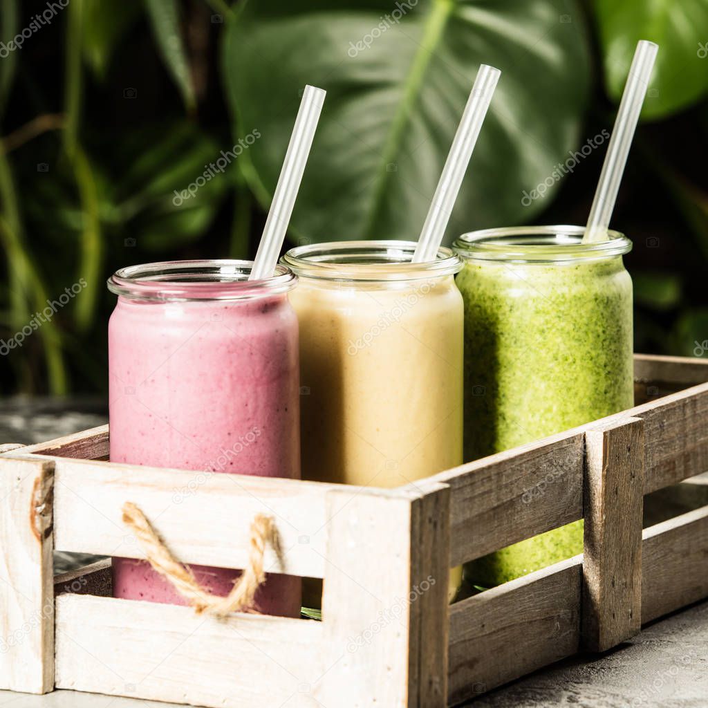 Fresh smoothies on tropical background