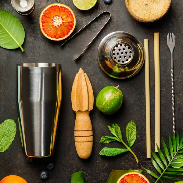 Cocktail making bar tools, shaker, tropical fruits and leaves — Stock Photo, Image