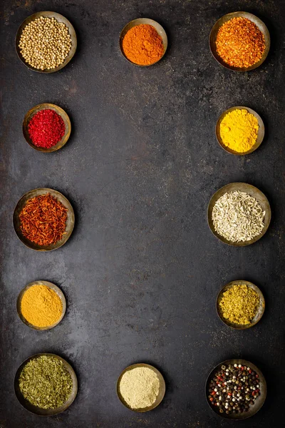 Various bowls of spices over dark background — Stock Photo, Image