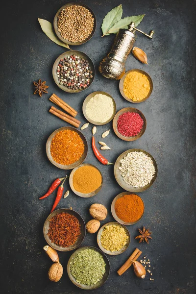 Various bowls of spices over dark background — Stock Photo, Image