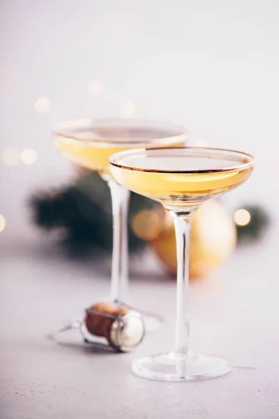 Two champagne glasses, cork and Christmas decorations — Stock Photo, Image