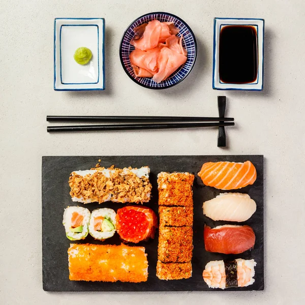 Flat-lay of sushi set on grey concrete background