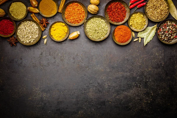 Various bowls of spices over dark background — Stock Photo, Image
