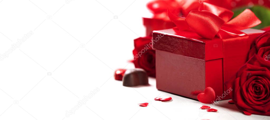 Valentine's Day concept. Gift with red bow on the wooden background Valentines gift box tied with a red satin ribbon bow on rustic background. 