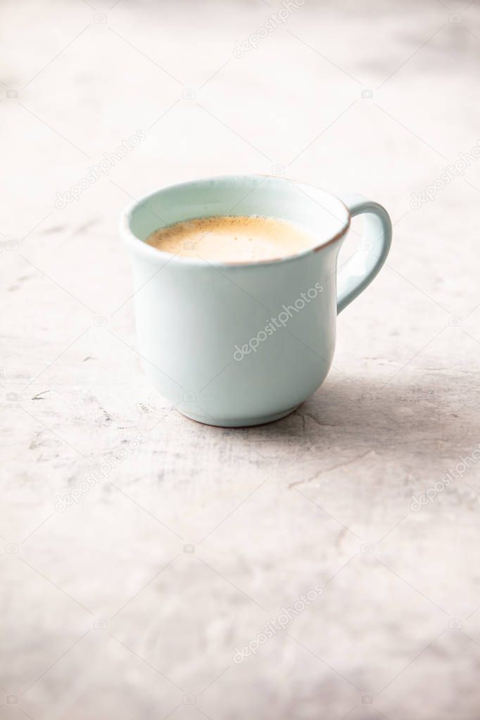 A cup of coffee on light grey background, coffee break concept
