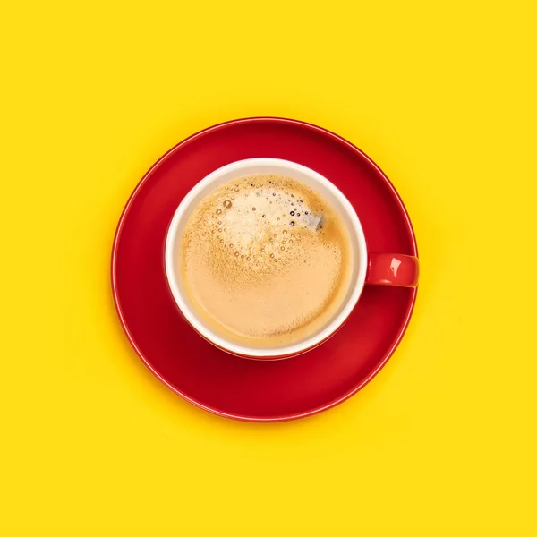Czerwony kubek kawy na żółtym tle — Zdjęcie stockowe