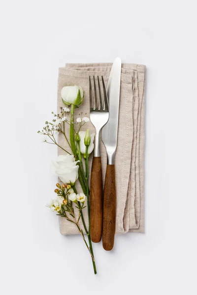 Flowers with fork and knife on white background — Stock Photo, Image