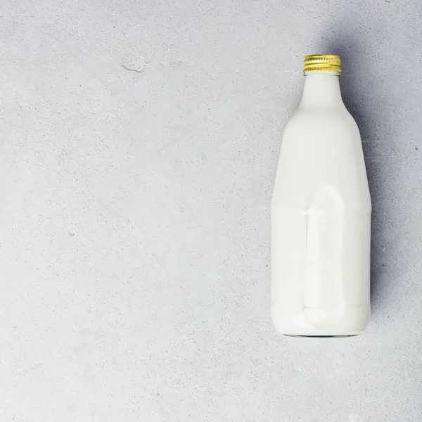 Flasche Milch auf grauem Betonhintergrund — Stockfoto