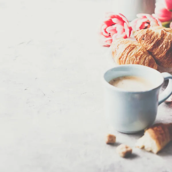 Café da manhã, croissants e tulipas de primavera em fundo cinza claro — Fotografia de Stock