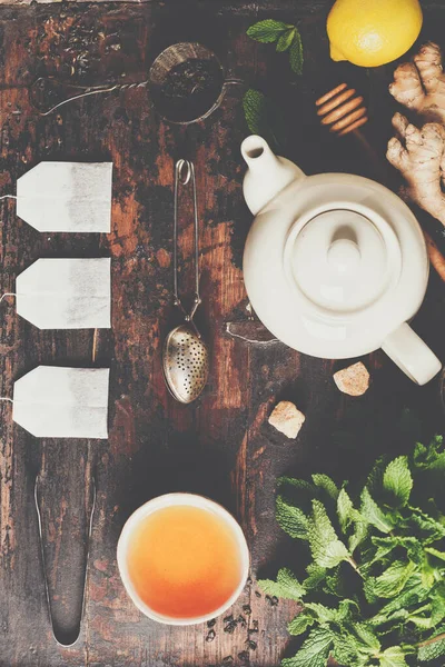 Склад чаю на сільському тлі: чай, м'ята, лимон, імбир . — стокове фото