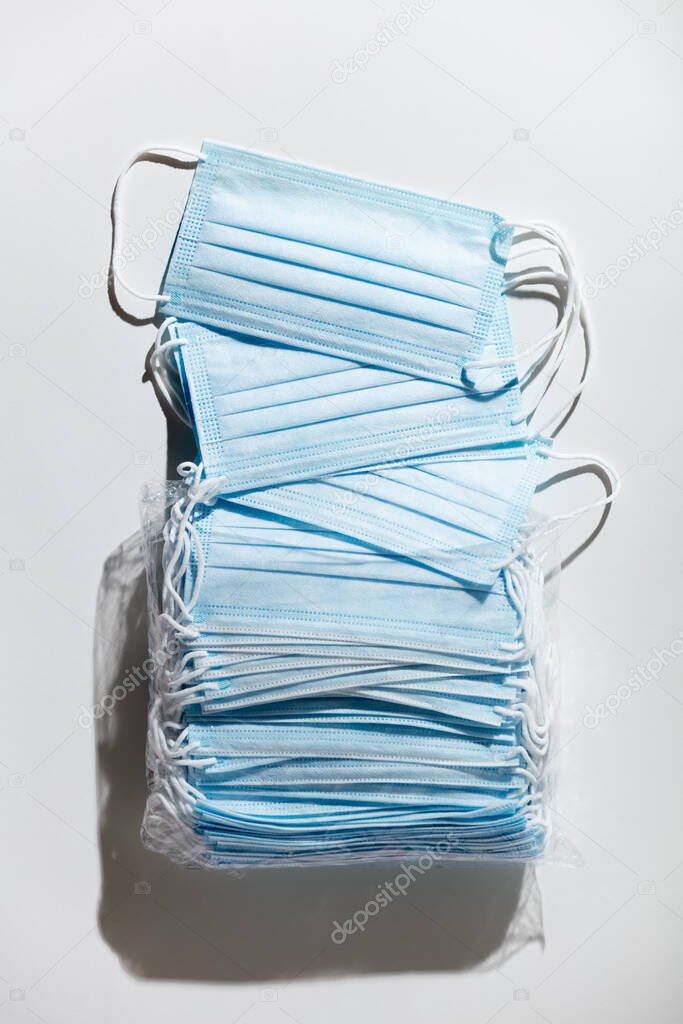 Stack of facial medical masks, white background, close up. The most sought after coronavirus covid-19 protection item in worldwide.