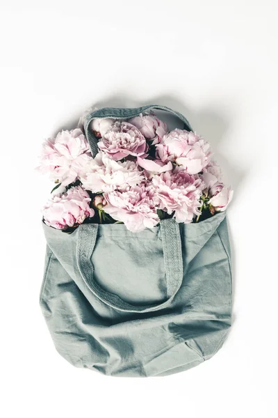 Blue cotton eco tote bag with peony flowers on white background, flat lay — Stock Photo, Image