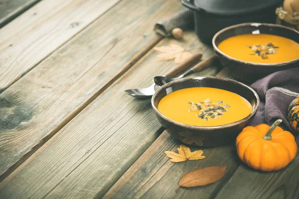 Pumpkin soup on wooden table, space for text — Stock Photo, Image