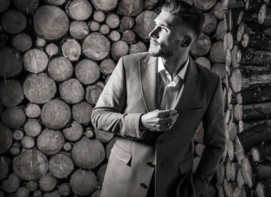 Genç güzel moda ceket adam, ahşap arka plan karşı portresi. Siyah-beyaz portre.