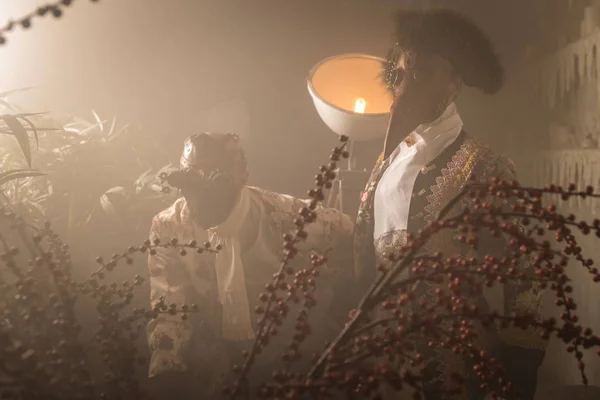 Actors in steam punk masks and antique costumes indoor.