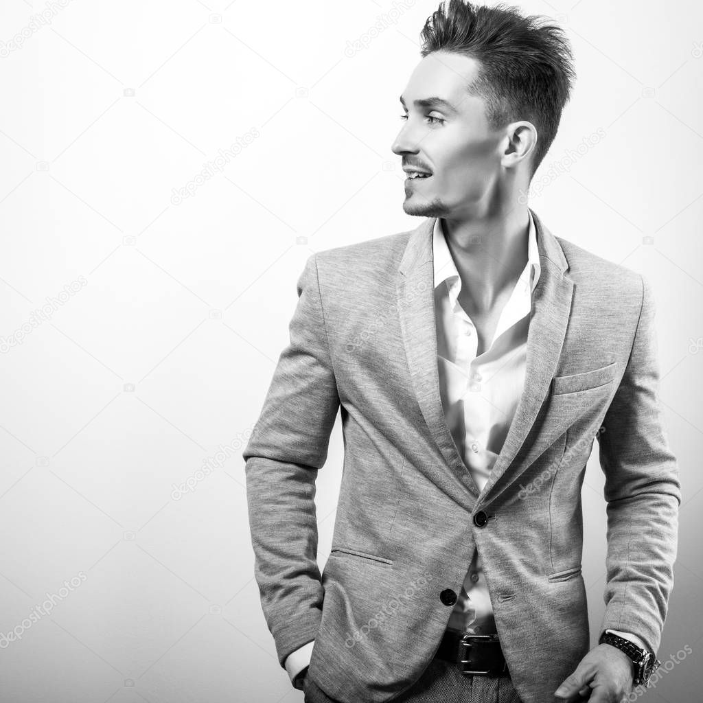 Handsome young elegant man in grey jacket. Black-white portrait.