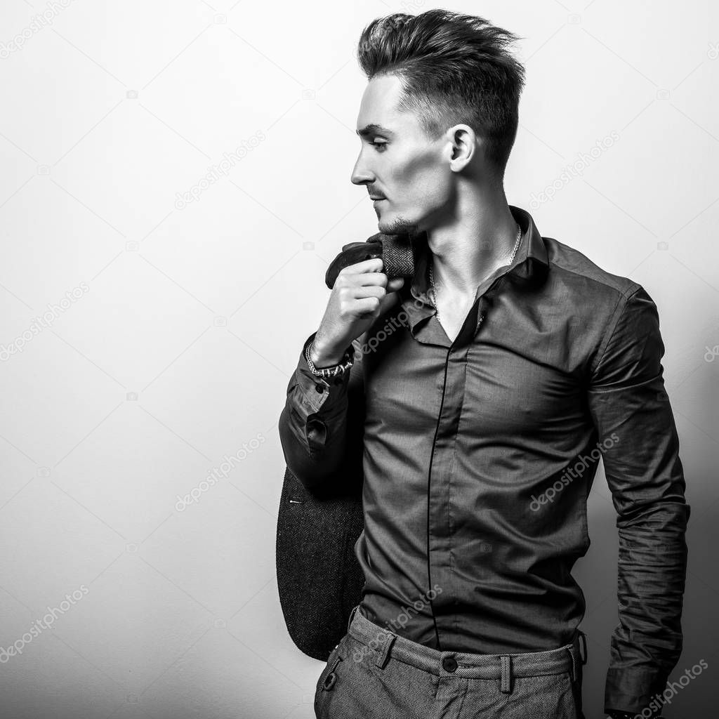 Handsome young elegant man in shirt. Black-white photo.