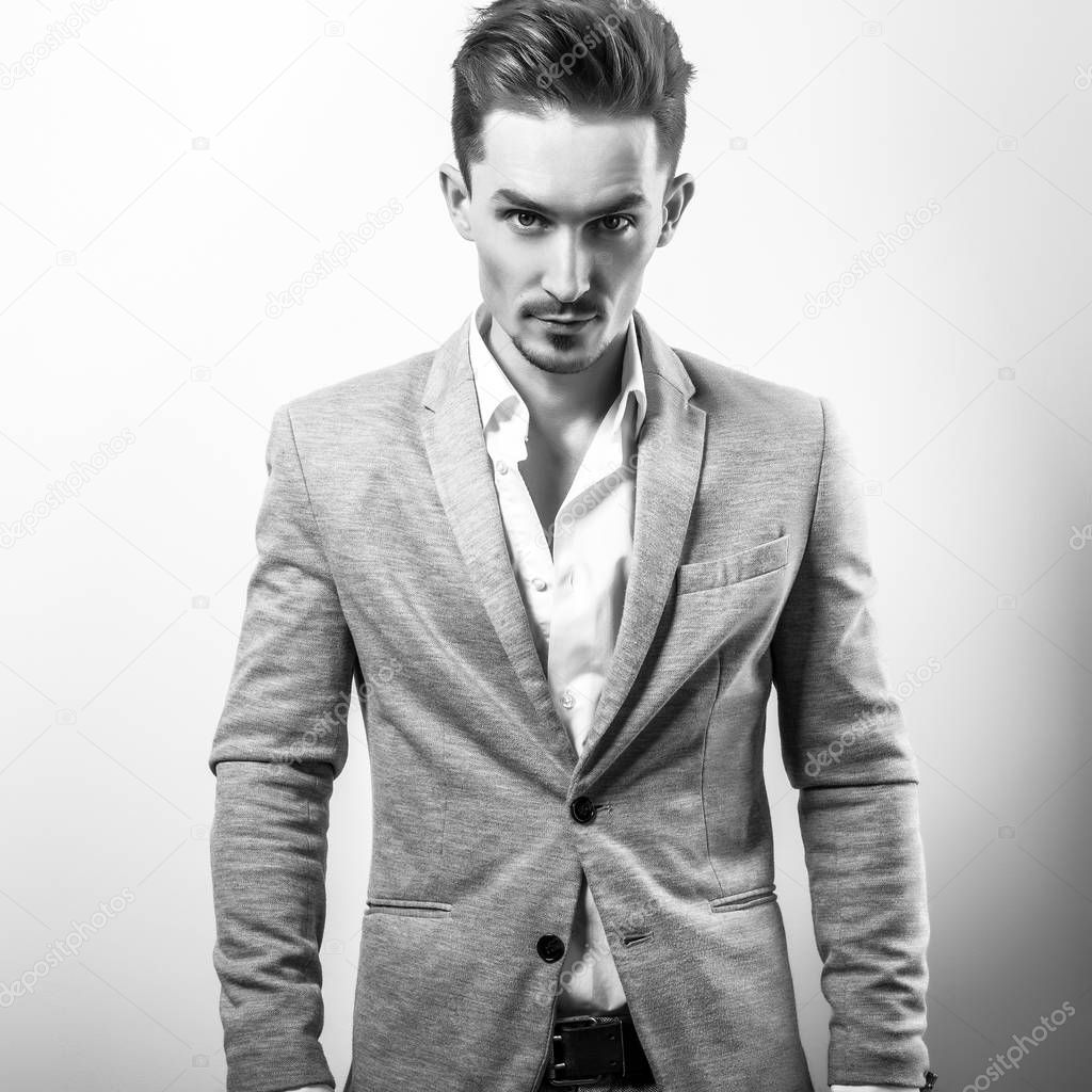 Handsome young elegant man in grey jacket. Black-white photo.