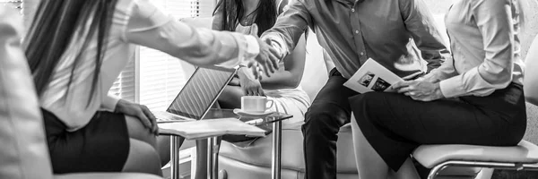 Group of business people at work black-white photo. Employers hands close-up.