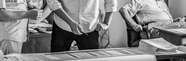 Group of business people at work black-white photo. Employers hands close-up.