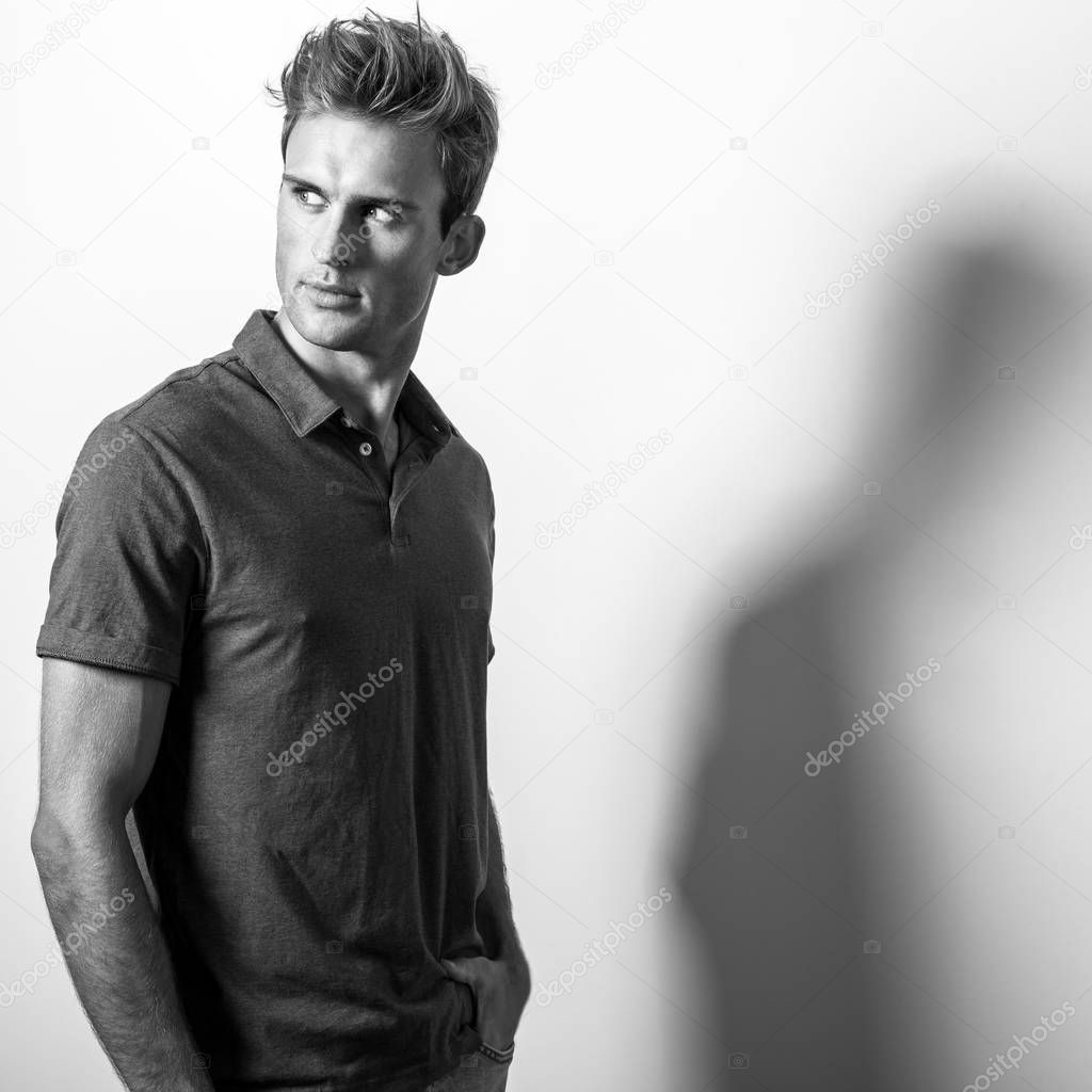 Elegant young handsome man in classic shirt. Black-white portrait.