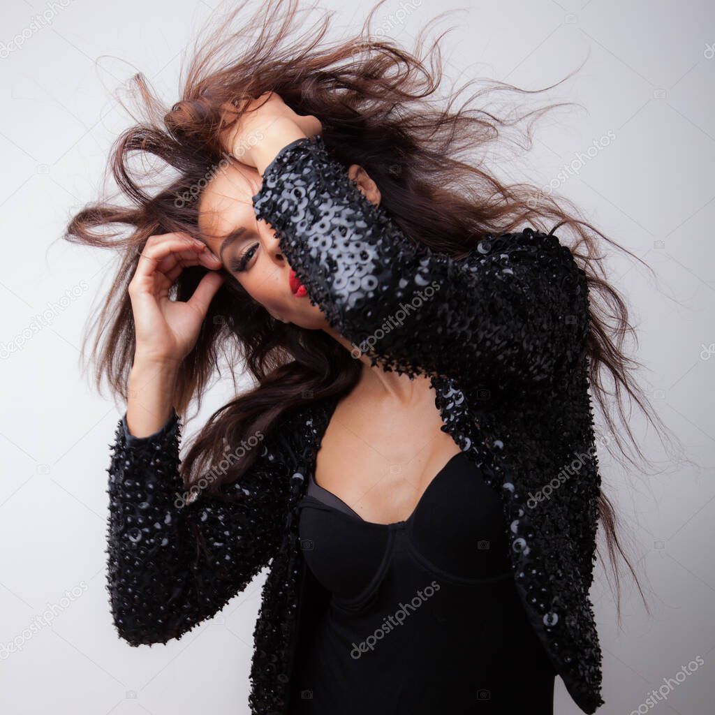 Young beautiful stylish girl posing in studio.