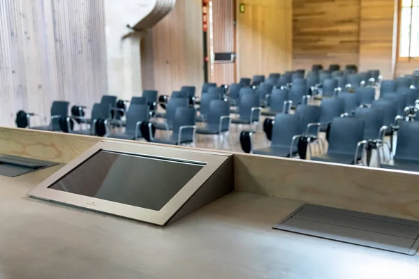 Presentation Screen in front of a row of chairs on a modern meeting room.