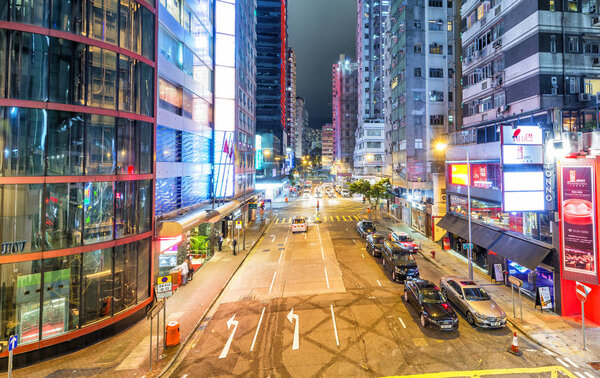 HONG KONG - APRIL 2014: City skyscrapers and traffic at night. Hong Kong attracts 25 million people annually.