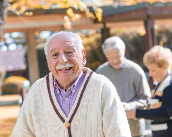 Elder people relaxing outdoor in rehab hospital garden.