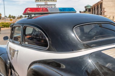 WILLIAMS, AZ - JUNE 29, 2018: Historic Police car along Route 66. This is the most famous historic route in the US. clipart